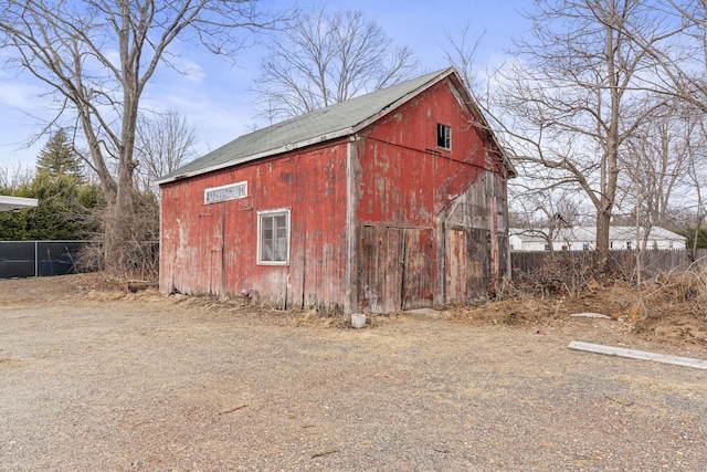 view of barn with fence