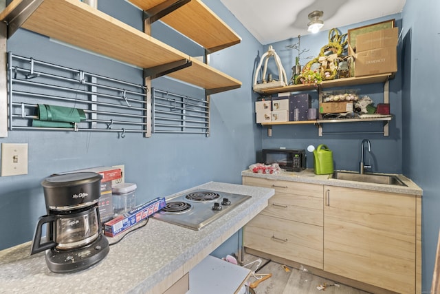 kitchen featuring a sink, black microwave, stainless steel electric stovetop, wood finished floors, and open shelves