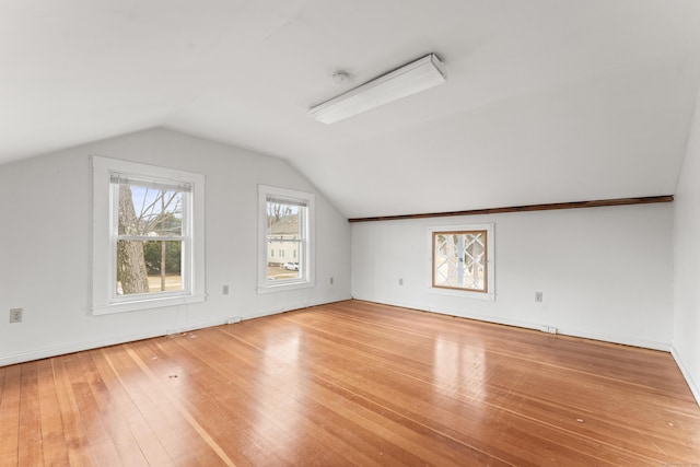 bonus room featuring hardwood / wood-style flooring and lofted ceiling