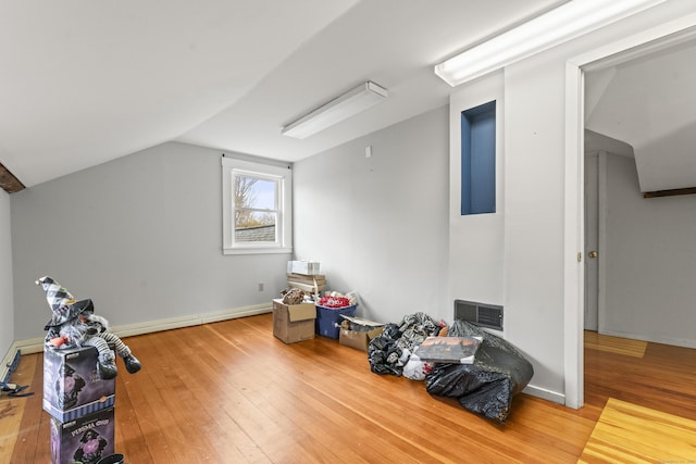 bonus room featuring hardwood / wood-style flooring, baseboards, visible vents, and lofted ceiling