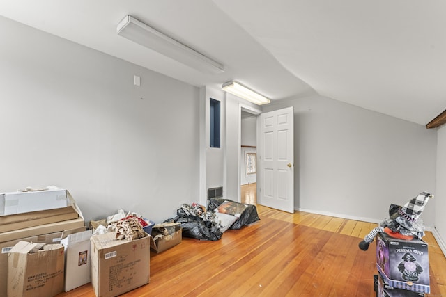 bonus room with vaulted ceiling and hardwood / wood-style floors