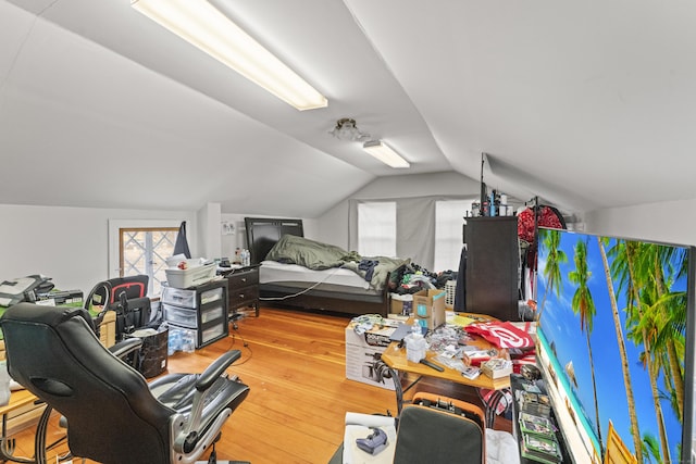 bedroom featuring wood finished floors and vaulted ceiling