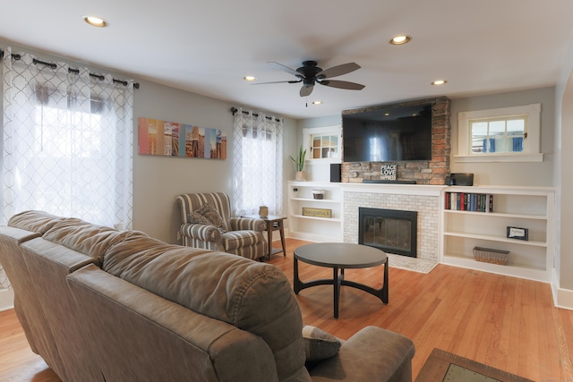 living room with ceiling fan, recessed lighting, wood finished floors, and a large fireplace