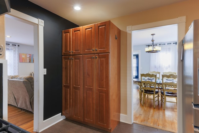 hall with recessed lighting, baseboards, and dark wood-type flooring