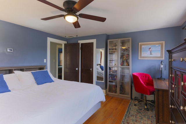 bedroom with visible vents, a closet, ceiling fan, and light wood finished floors