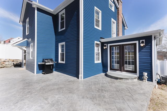 back of house featuring a patio and french doors