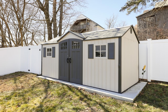 view of shed with a fenced backyard