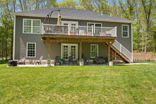 back of property with french doors, a patio, and a lawn