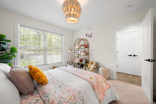 carpeted bedroom with an inviting chandelier