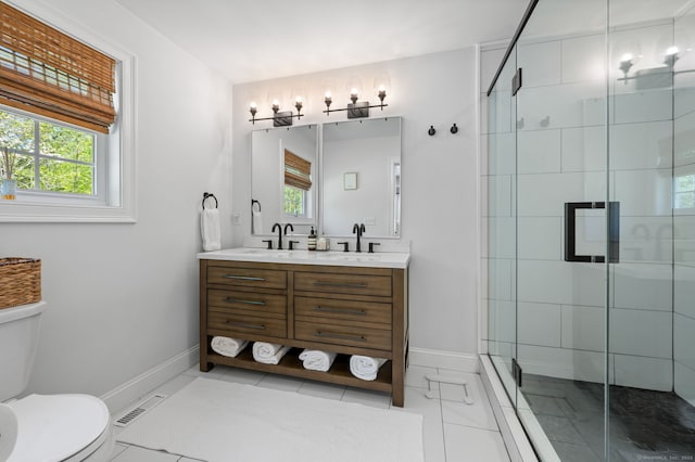 full bathroom featuring vanity, a shower stall, toilet, and visible vents