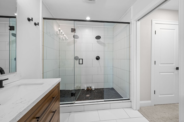 full bathroom with a stall shower, vanity, and tile patterned flooring