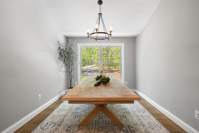 dining room with dark wood finished floors, baseboards, and a chandelier