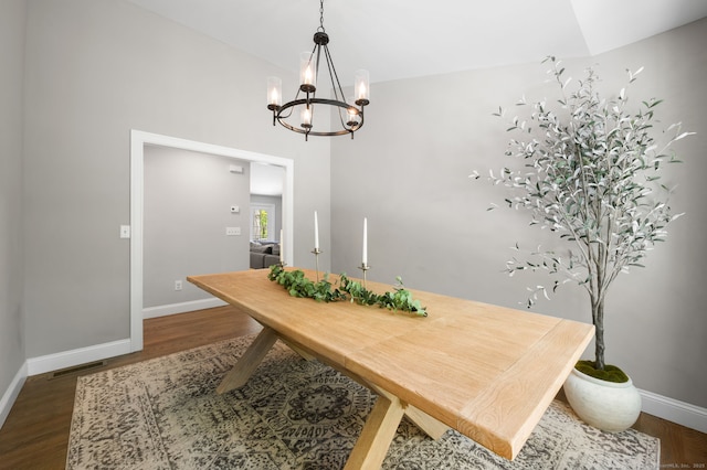 dining area with visible vents, baseboards, an inviting chandelier, and dark wood-style floors