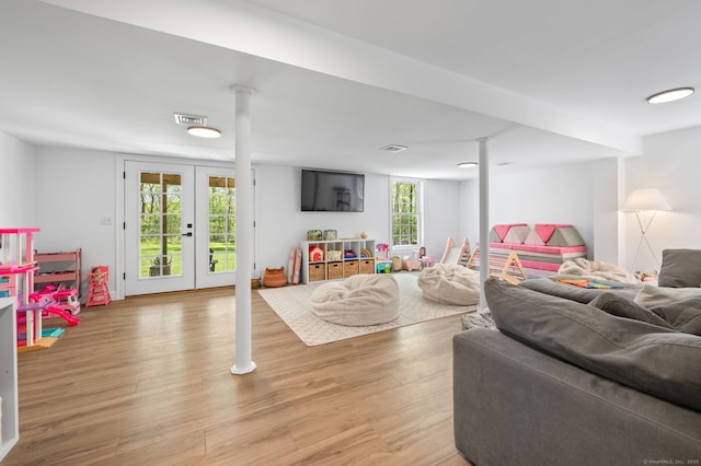 playroom featuring light wood-type flooring, visible vents, and french doors