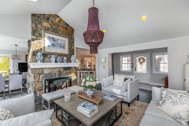 52 S Lake Shore Dr, Brookfield, CT 06804 - living room with a chandelier, a fireplace, wood finished floors, high vaulted ceiling, and ornamental molding