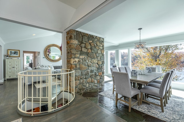 dining room featuring lofted ceiling, wood finished floors, and an inviting chandelier