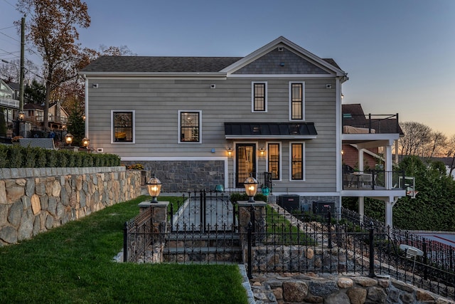 view of front of home featuring a fenced front yard, a standing seam roof, roof with shingles, and metal roof