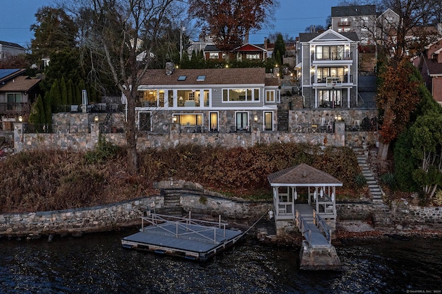 52 S Lake Shore Dr, Brookfield, CT 06804 - rear view of property featuring stone siding, a water view, and a chimney
