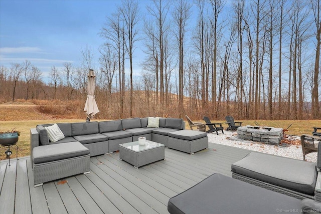 wooden terrace featuring an outdoor living space with a fire pit