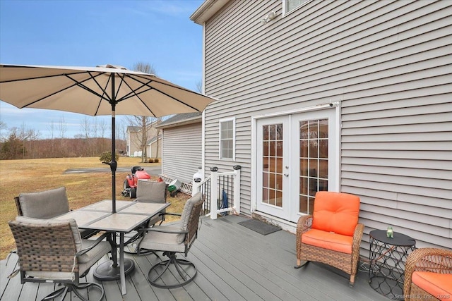 deck featuring outdoor dining space and french doors