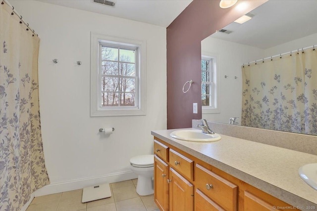 bathroom with visible vents, toilet, a sink, tile patterned flooring, and double vanity