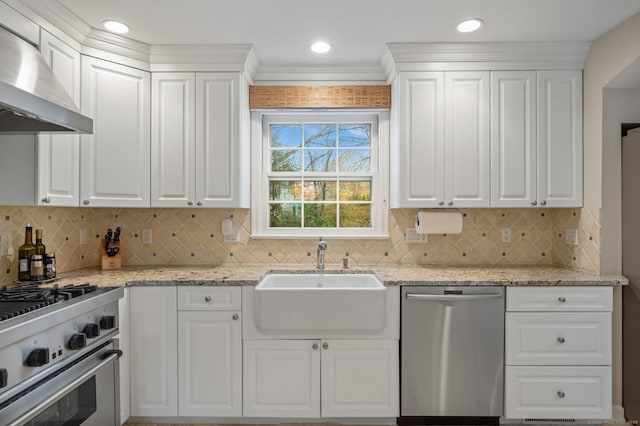 24 Laforge Rd, Darien, CT 06820 - kitchen with appliances with stainless steel finishes, wall chimney exhaust hood, white cabinetry, and decorative backsplash