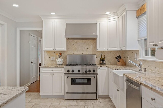 24 Laforge Rd, Darien, CT 06820 - kitchen with custom exhaust hood, appliances with stainless steel finishes, recessed lighting, white cabinetry, and decorative backsplash