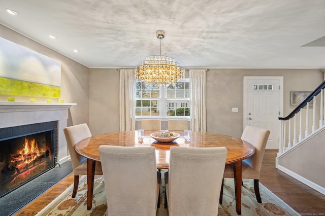 24 Laforge Rd, Darien, CT 06820 - dining area with a lit fireplace, stairway, a chandelier, wood finished floors, and recessed lighting