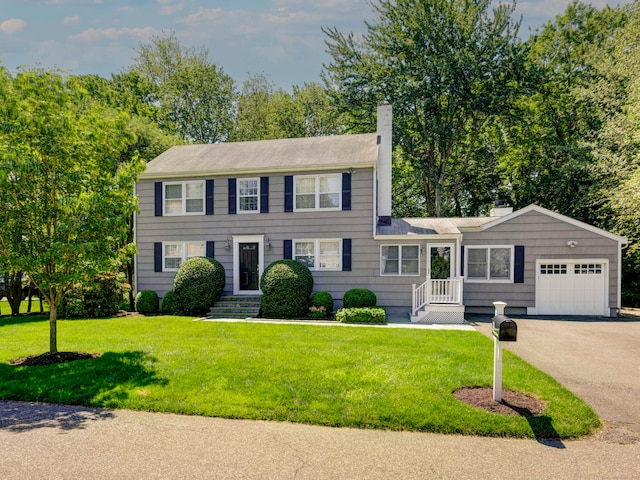 24 Laforge Rd, Darien, CT 06820 - view of front of property featuring a chimney, a garage, driveway, and a front yard