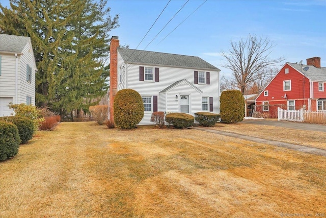 view of front of property with a front yard and a chimney