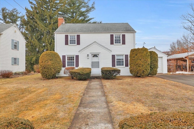 view of front of house with a chimney and a front lawn