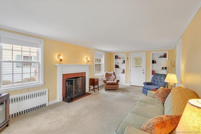 carpeted living room with radiator, built in features, baseboards, a fireplace, and crown molding