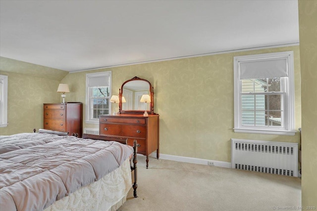 carpeted bedroom featuring radiator and baseboards