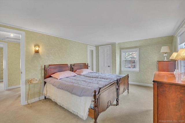 bedroom featuring baseboards and light carpet