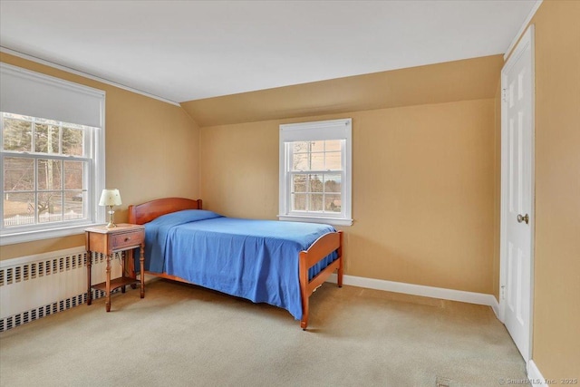 bedroom featuring baseboards, lofted ceiling, carpet, and radiator heating unit