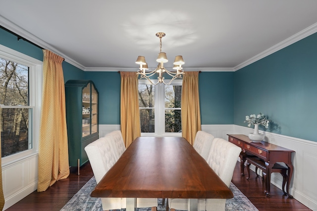 dining area featuring wainscoting, wood finished floors, a wealth of natural light, and an inviting chandelier