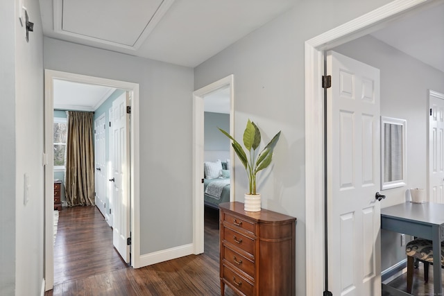 corridor featuring dark wood-style floors and baseboards