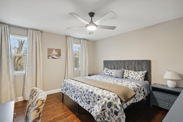 bedroom featuring multiple windows, ceiling fan, baseboards, and wood finished floors