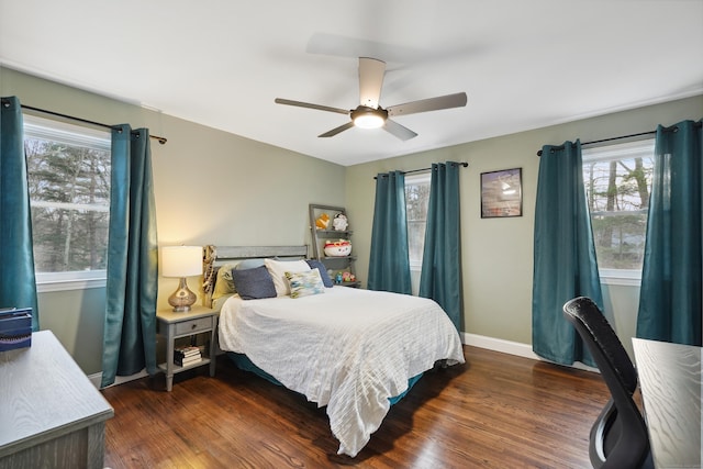 bedroom with ceiling fan, dark wood finished floors, and baseboards