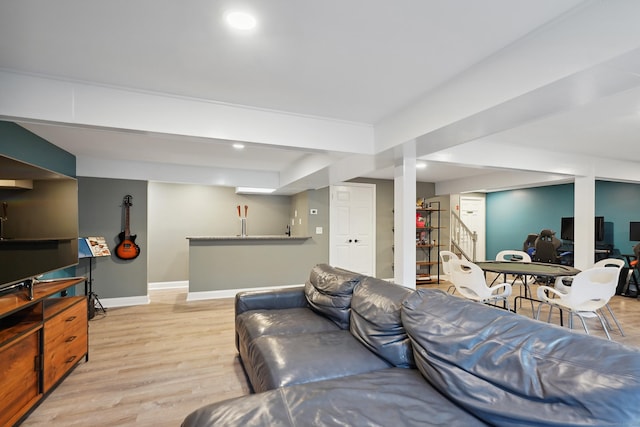 living room featuring baseboards, stairway, recessed lighting, and light wood-style floors