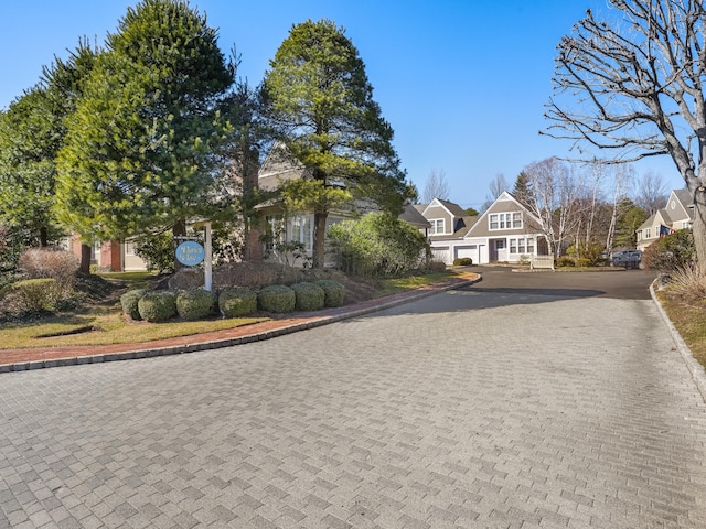 view of front of home with decorative driveway and a garage