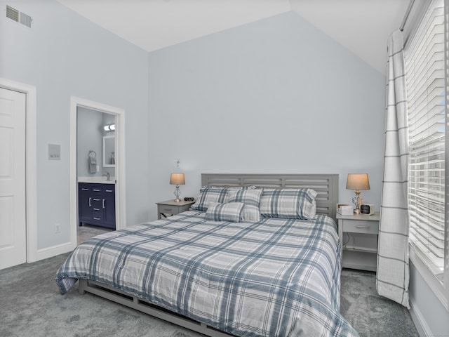 bedroom with visible vents, connected bathroom, baseboards, carpet, and vaulted ceiling