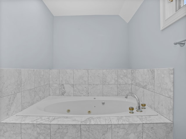 full bathroom featuring a whirlpool tub and vaulted ceiling