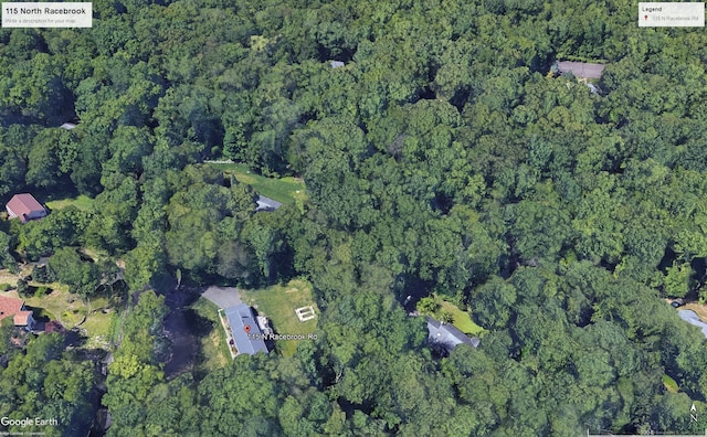 bird's eye view featuring a wooded view