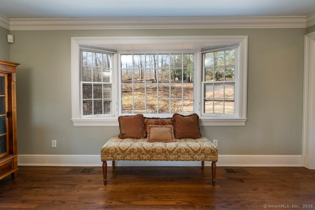 living area featuring crown molding, baseboards, and wood finished floors