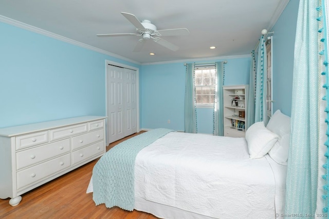 bedroom with a closet, wood finished floors, a ceiling fan, and ornamental molding