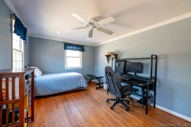 bedroom with a ceiling fan, crown molding, baseboards, and wood finished floors