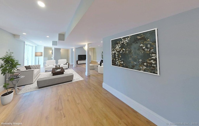 living room featuring recessed lighting, wood finished floors, and baseboards