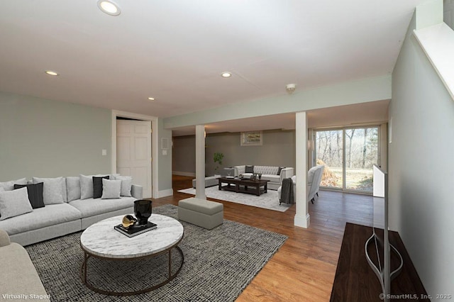 living room with recessed lighting, light wood-type flooring, baseboards, and decorative columns