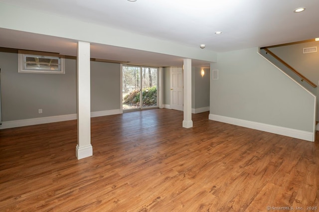 below grade area with visible vents, recessed lighting, wood finished floors, and baseboards